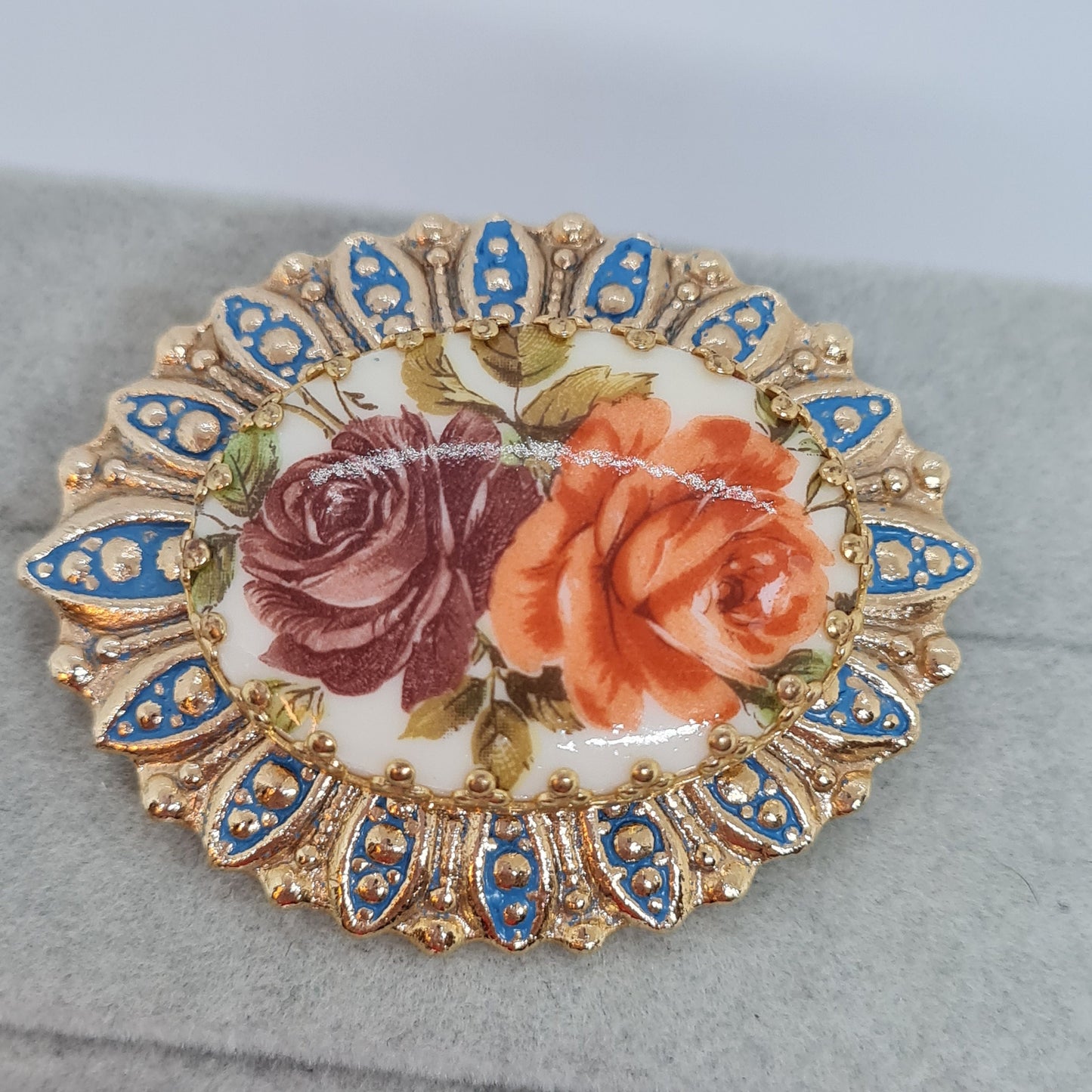 Vintage floral brooch Gold tone metal with blue enamel and oval plastic cabochon Flower brooch pin