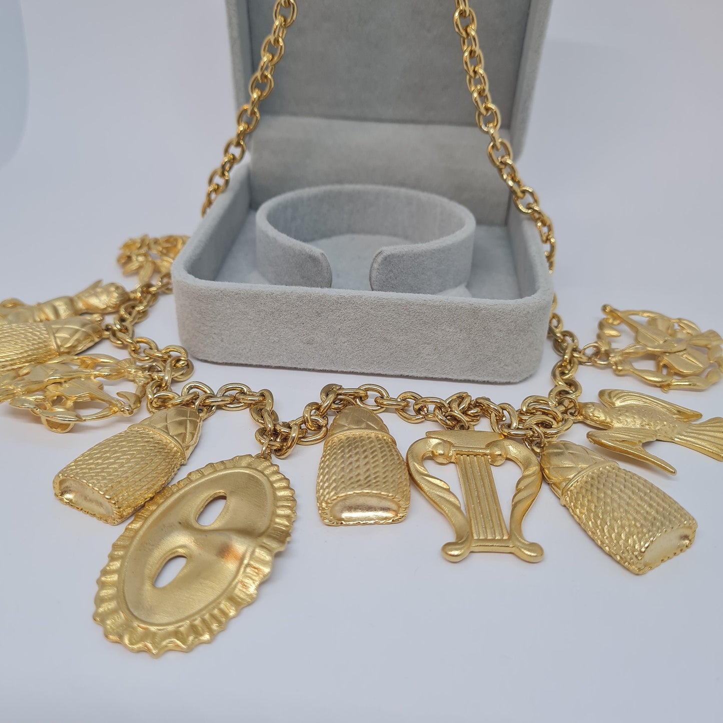 Vintage music-themed pendant necklace. Gold-tone metal chain with Arfa, tassel, mask, and violin pendants. Original pendant necklace.