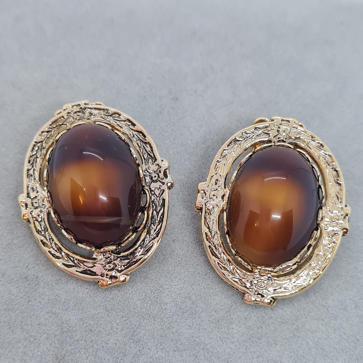 Vintage oval clip on earrings Gold tone textured metal with brown art glass cabochon clip earrings