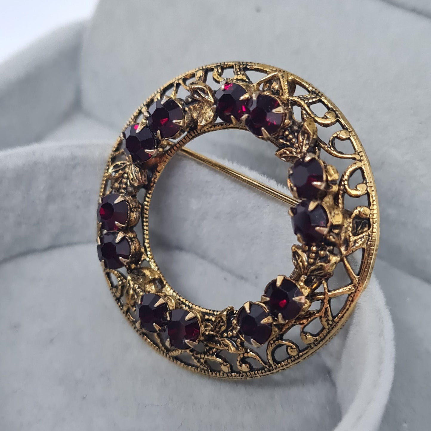 Vintage rhinestone wreath brooch Textured gold-tone metal with garnet glass rhinestones brooch pin