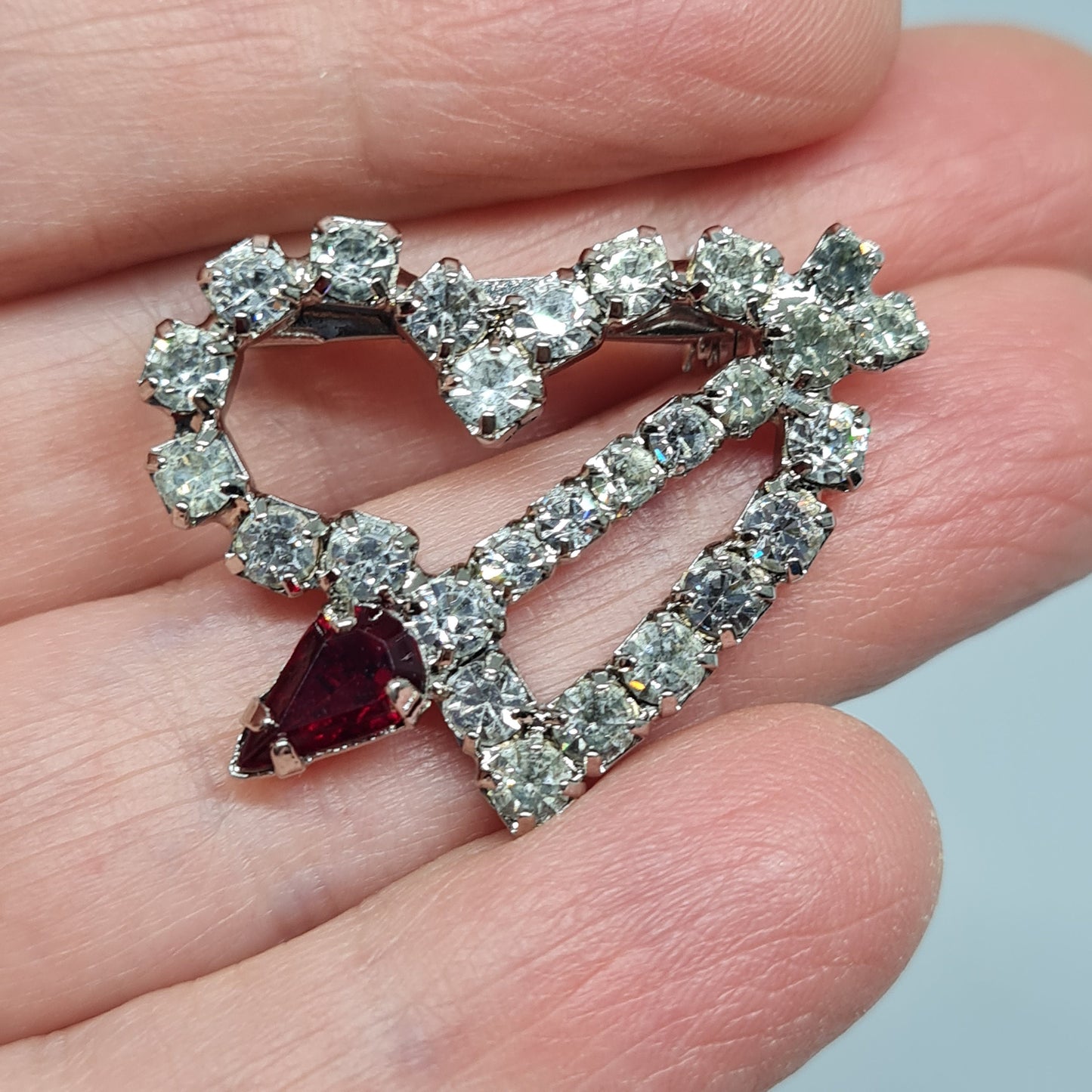 Vintage sparkly heart brooch. Silver-tone metal brooch pin with red and clear rhinestones. Gift for Valentine's Day.