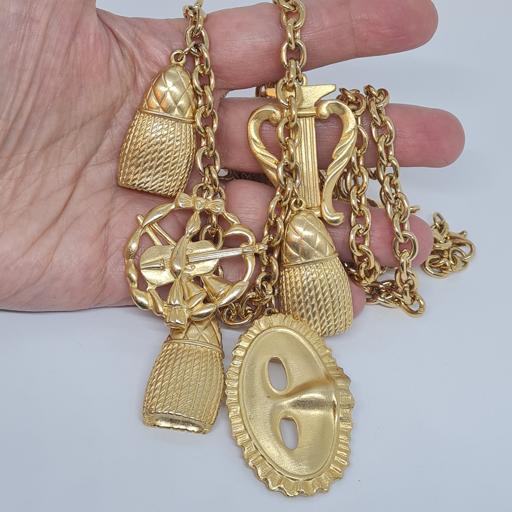 Vintage music-themed pendant necklace Gold-tone metal chain with Arfa, tassel, mask, violin pendants Original pendant necklace