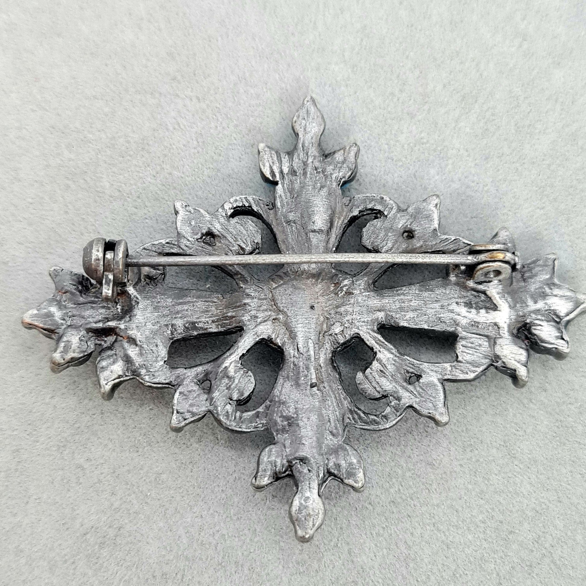 Vintage Victorian style brooch Silver tone metal with blue plastic and glass rhinestones brooch pin