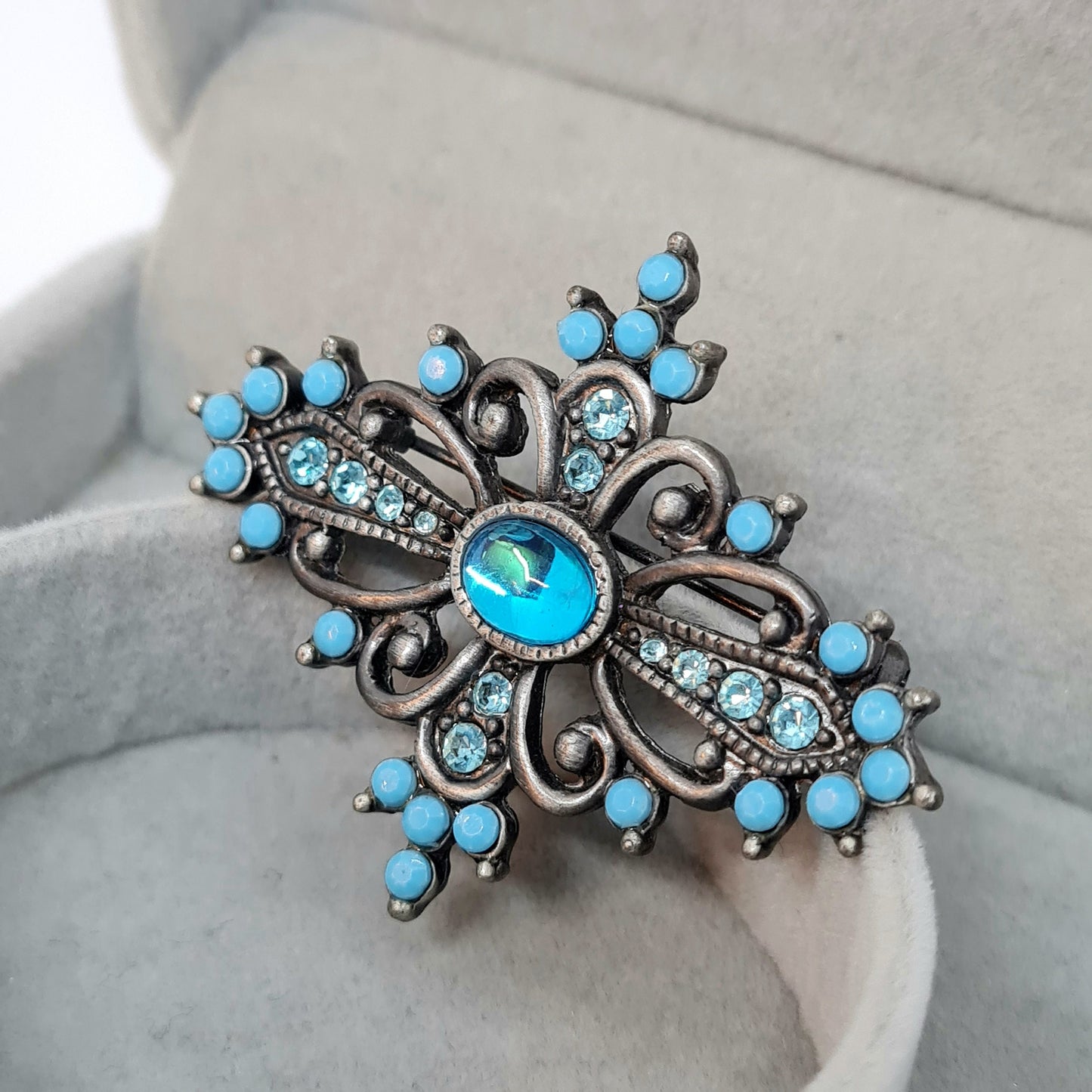 Vintage Victorian style brooch Silver tone metal with blue plastic and glass rhinestones brooch pin