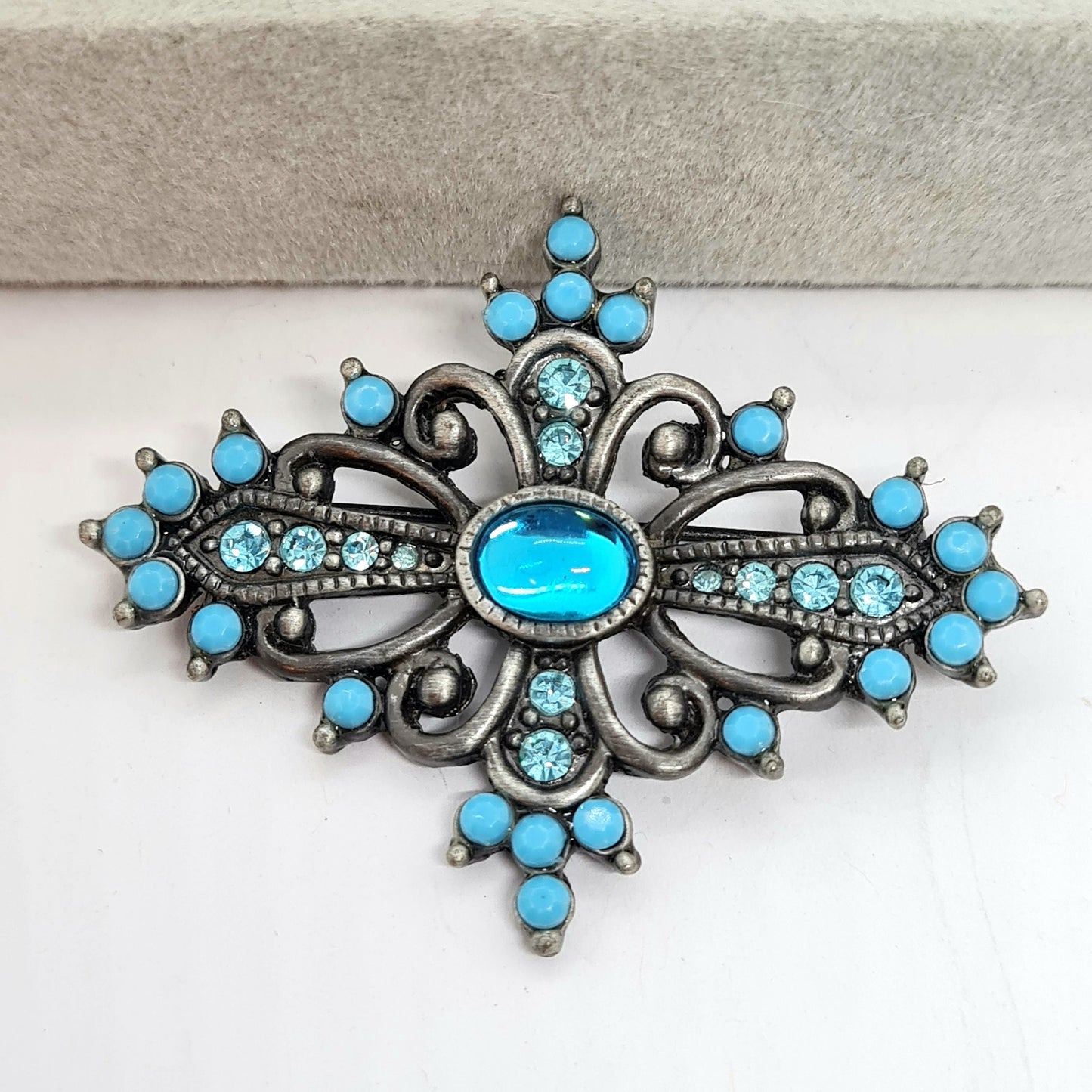 Vintage Victorian style brooch Silver tone metal with blue plastic and glass rhinestones brooch pin