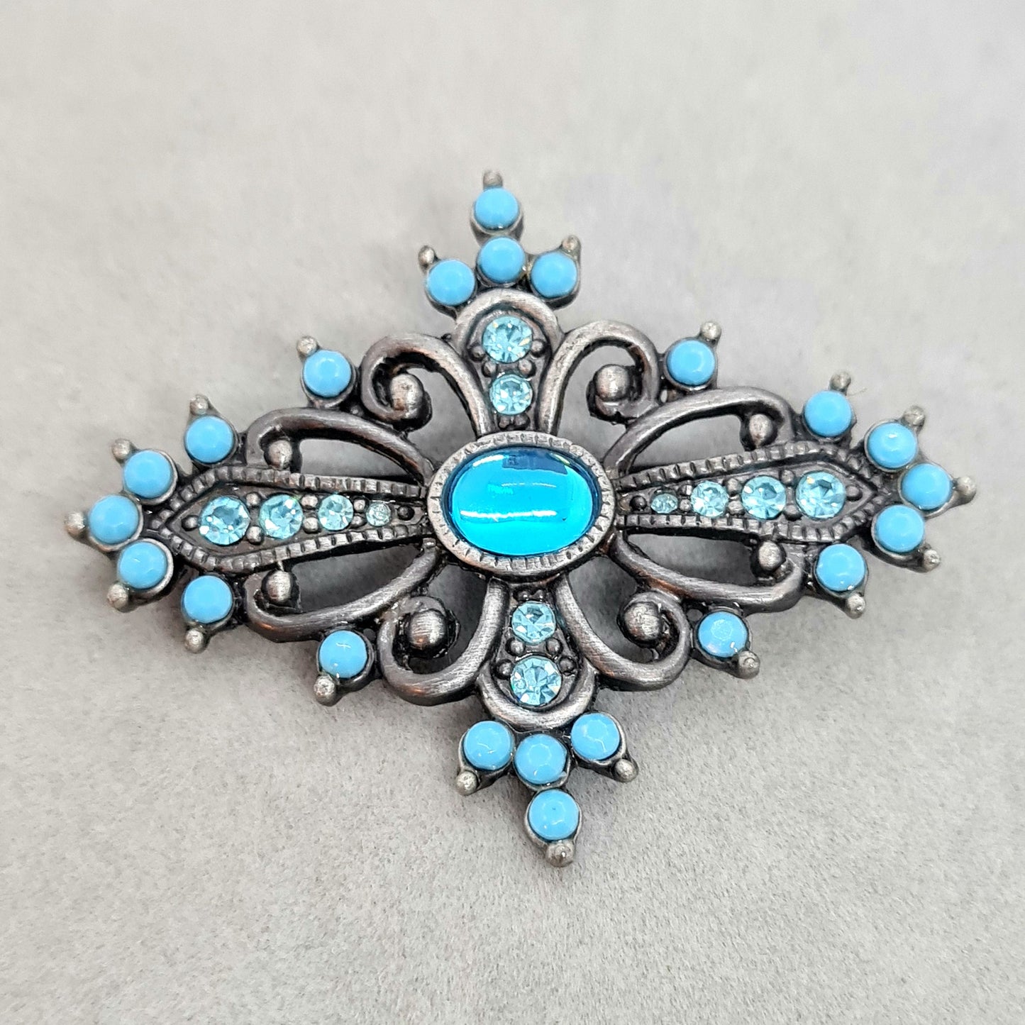 Vintage Victorian style brooch Silver tone metal with blue plastic and glass rhinestones brooch pin