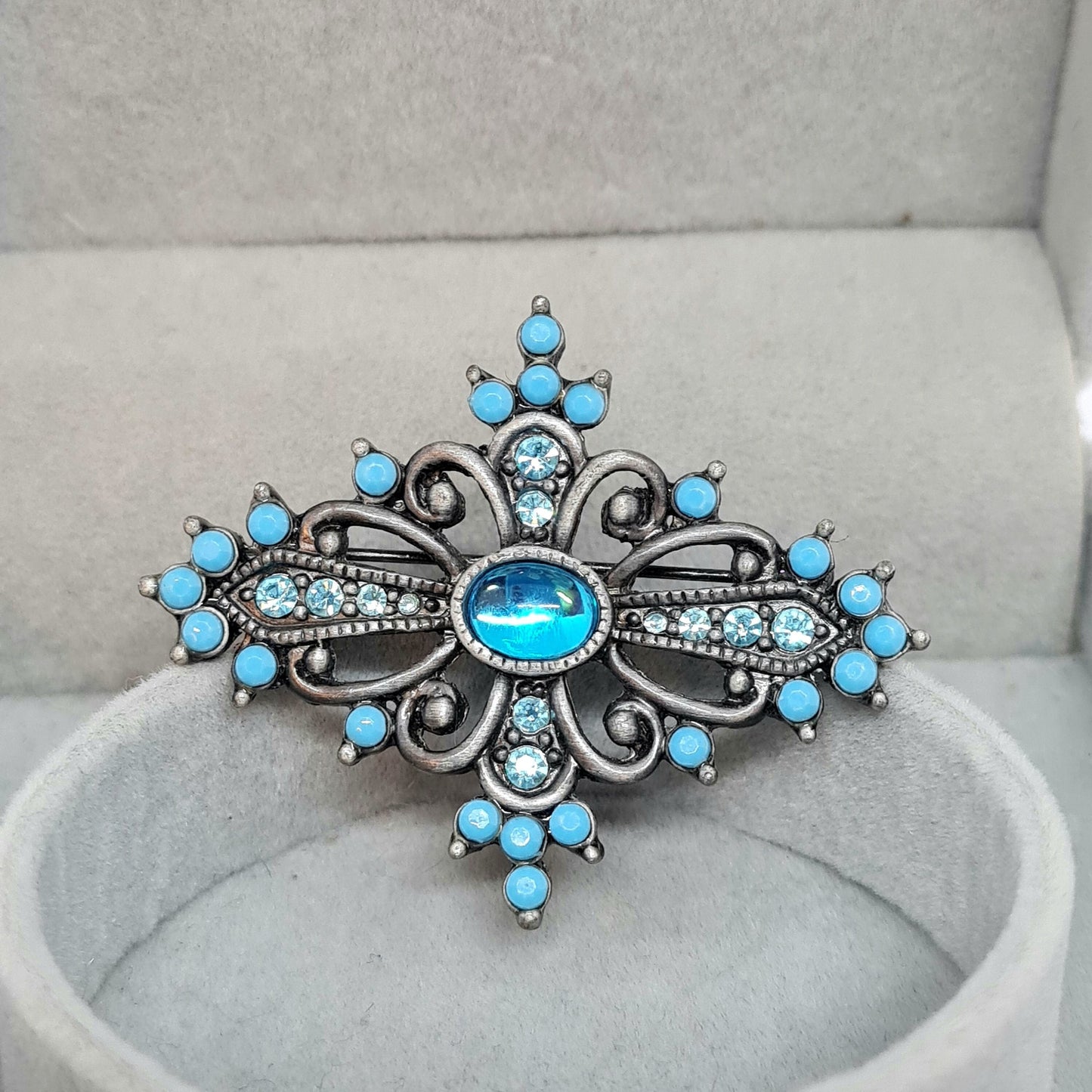Vintage Victorian style brooch Silver tone metal with blue plastic and glass rhinestones brooch pin