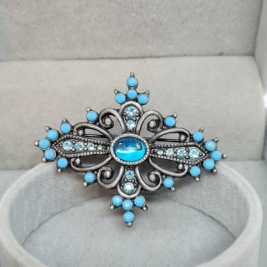 Vintage Victorian style brooch Silver tone metal with blue plastic and glass rhinestones brooch pin