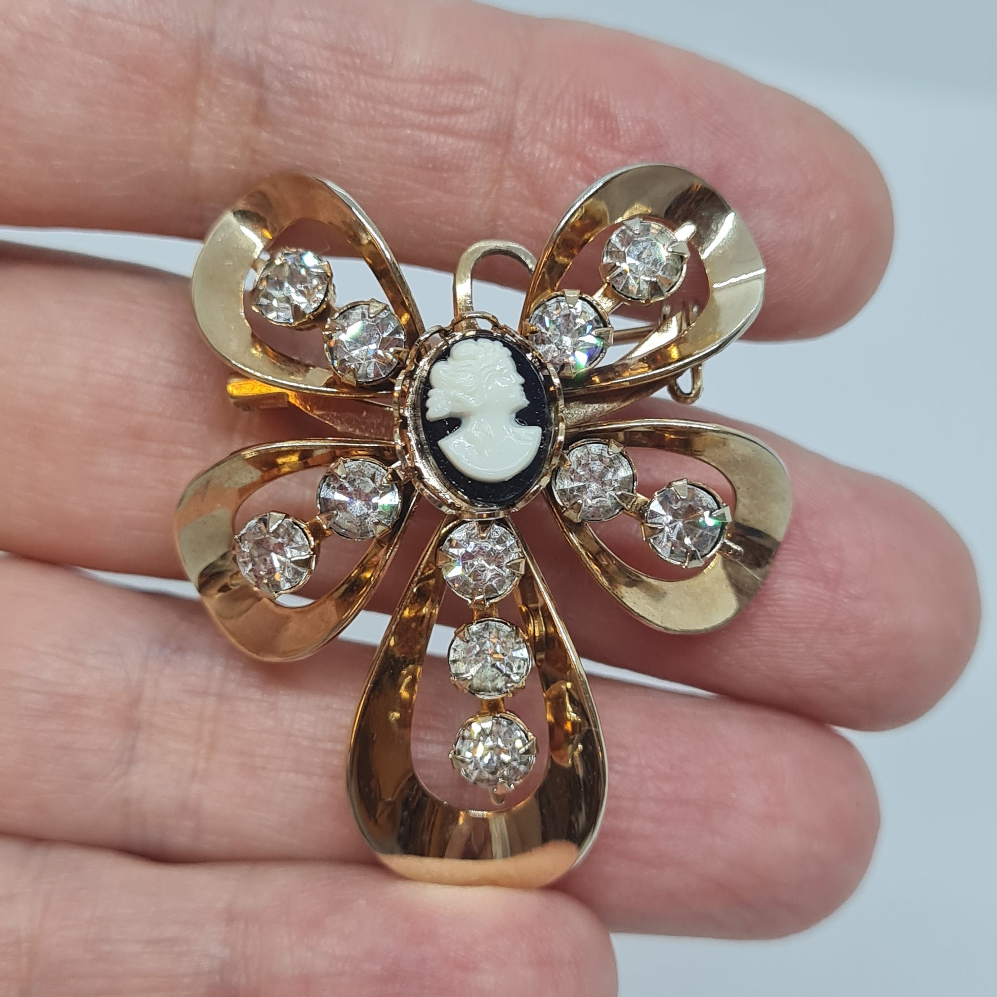 Vintage Cameo brooch pendant Gold tone metal with tiny black and white tone plastic cabochon and clear rhinestones