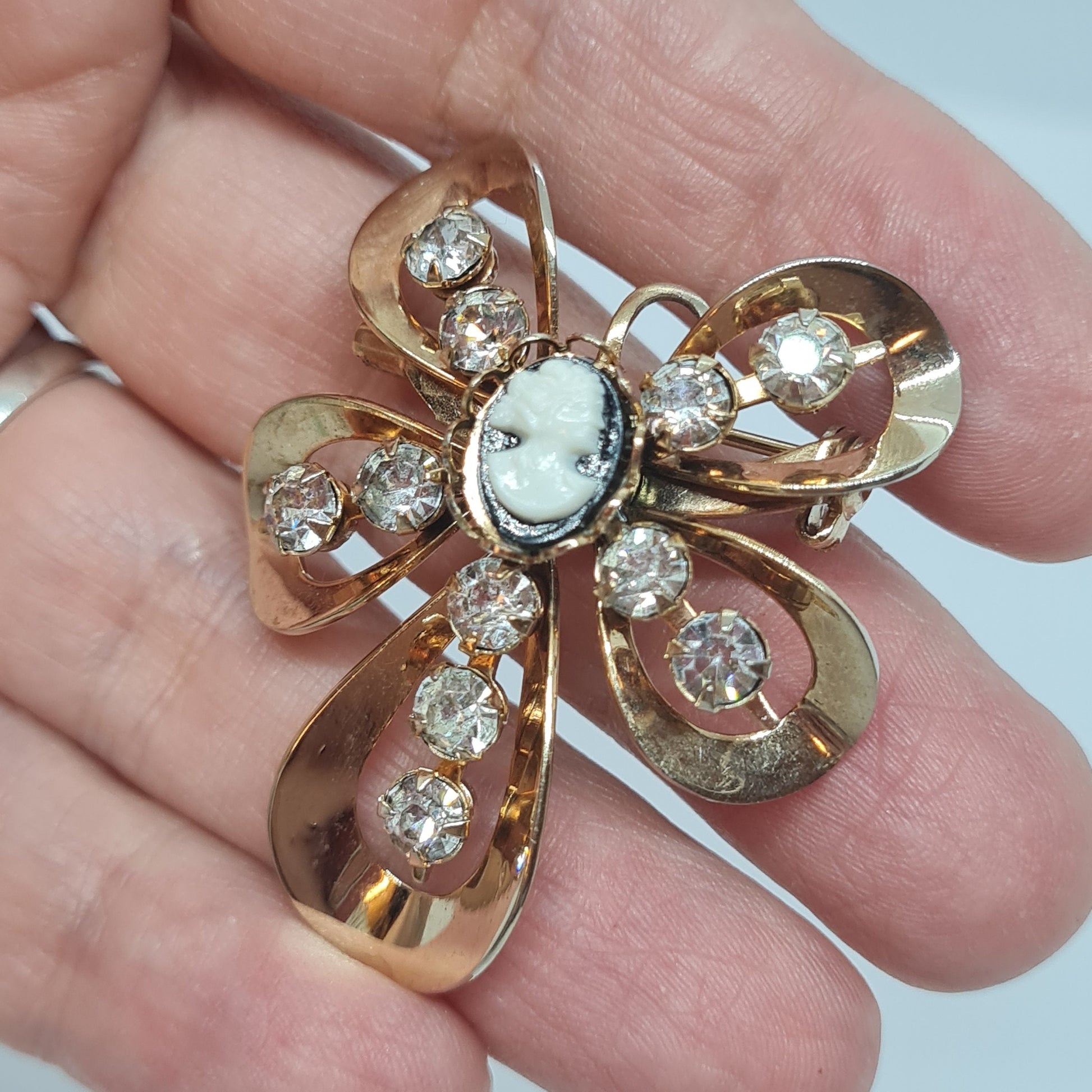 Vintage Cameo brooch pendant Gold tone metal with tiny black and white tone plastic cabochon and clear rhinestones