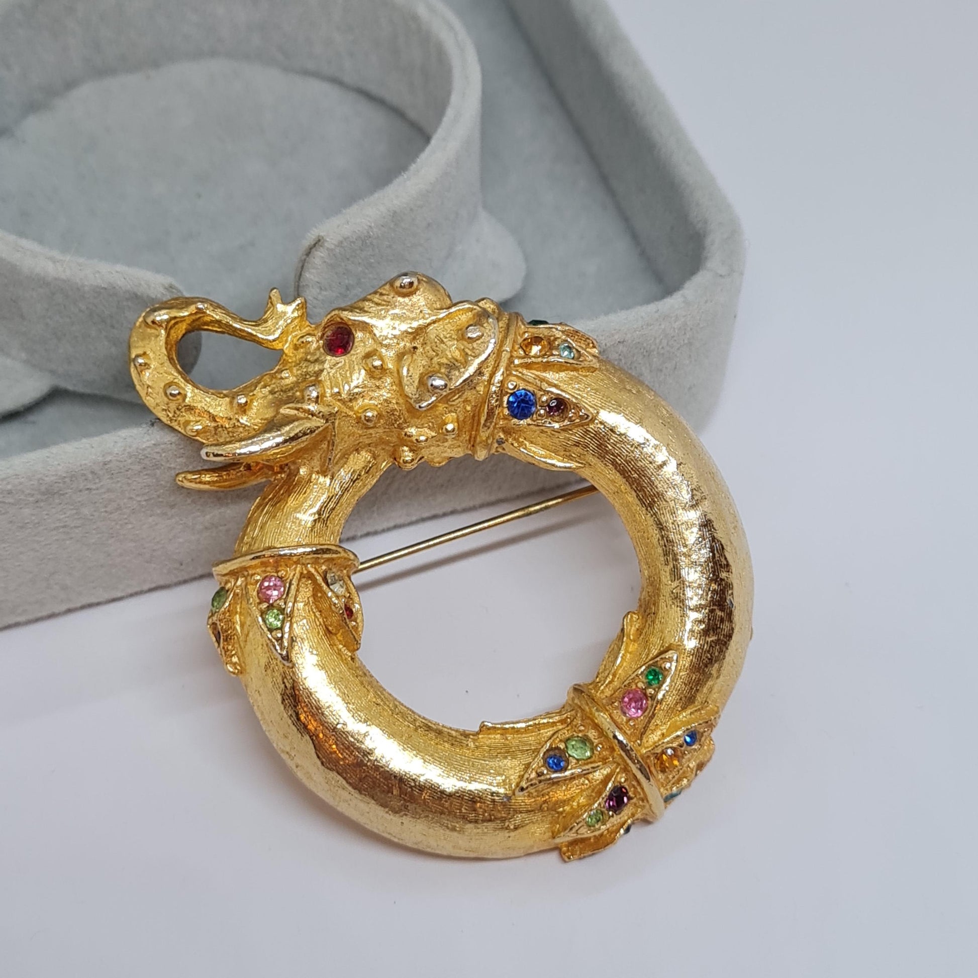 Vintage circus elephant brooch Circle gold-tone metal with rainbow glass rhinestone brooch pin