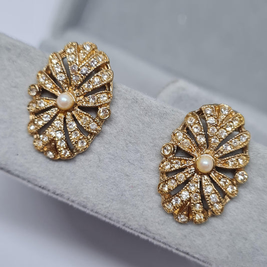 Vintage tiny clip-on earrings. Gold tone metal with white faux pearl and clear rhinestones. Gift for Christmas.