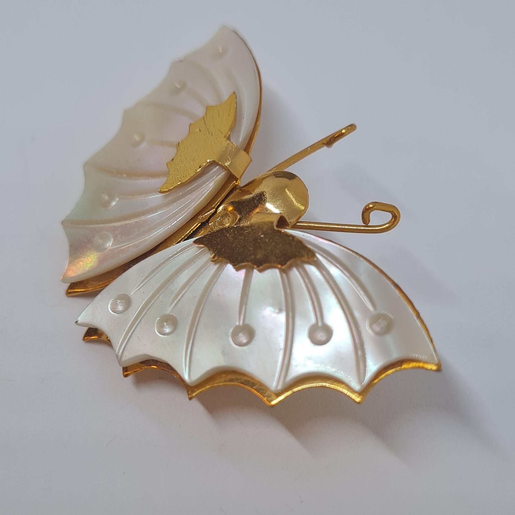 Vintage butterfly brooch pin. Gold-tone metal with Mother of pearl. Tiny and light butterfly brooch.