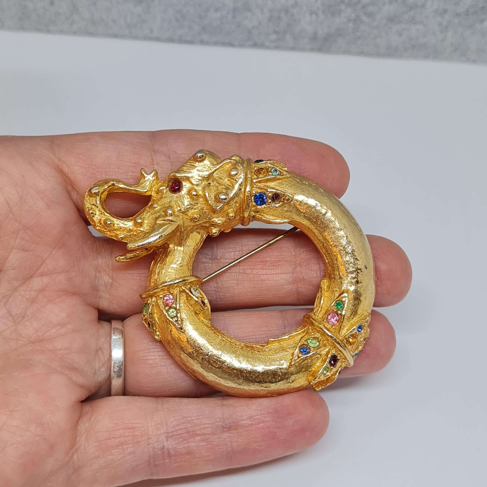 Vintage circus elephant brooch Circle gold-tone metal with rainbow glass rhinestone brooch pin