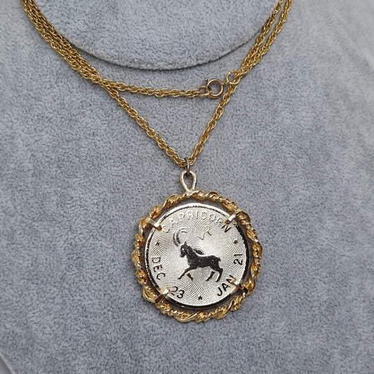 Vintage CAPRICORN zodiac sign pendant necklace. Gold-tone chain and coin pendant in a rope circle.
