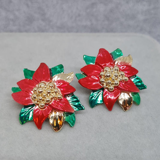 Vintage Christmas poinsettia earrings. Gold-tone metal with red and green enamel. Stud earrings for New Year.