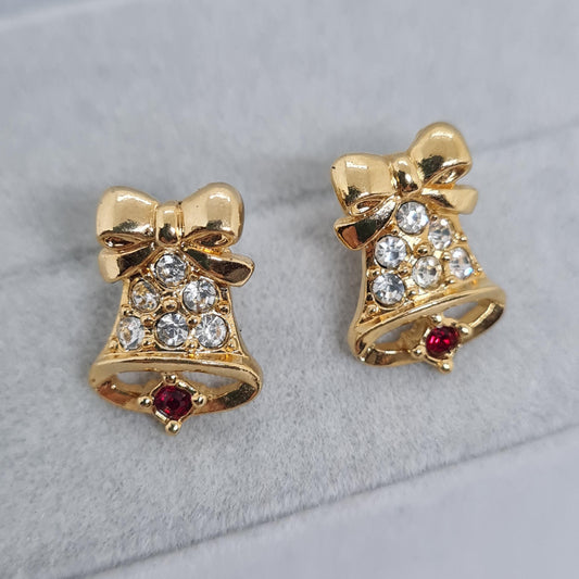 Vintage AVON jingle bell earrings, 1991. They are made of gold-tone metal and have red and clear rhinestones. These tiny stud earrings are perfect for Christmas.