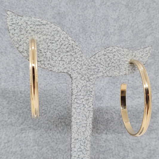 Vintage AVON hoop earrings, 1979. Gloss gold-tone metal huggie hoops.