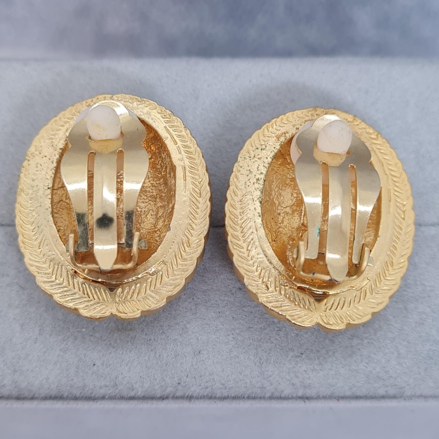Vintage heraldic style clip-on earrings Matte gold tone textured metal oval clip earrings