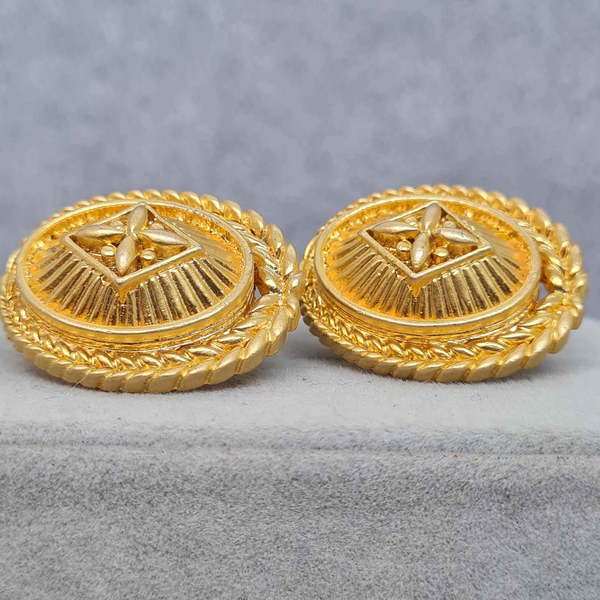 Vintage heraldic style clip-on earrings Matte gold tone textured metal oval clip earrings
