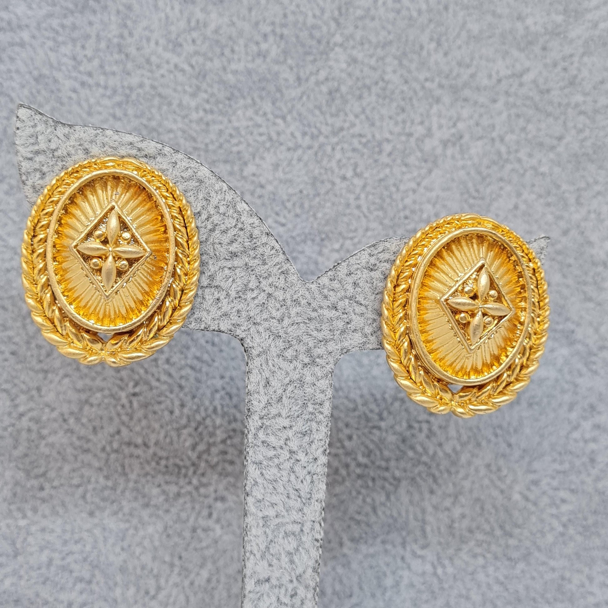 Vintage heraldic style clip-on earrings Matte gold tone textured metal oval clip earrings