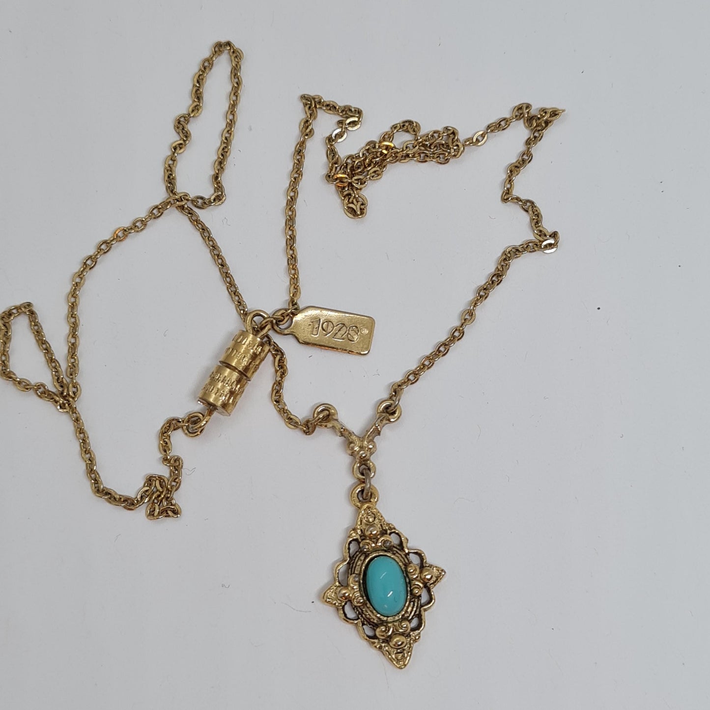 Vintage 1928 JEWELRY pendant necklace Gold-tone chain and tiny pendant with blue glass cabochon