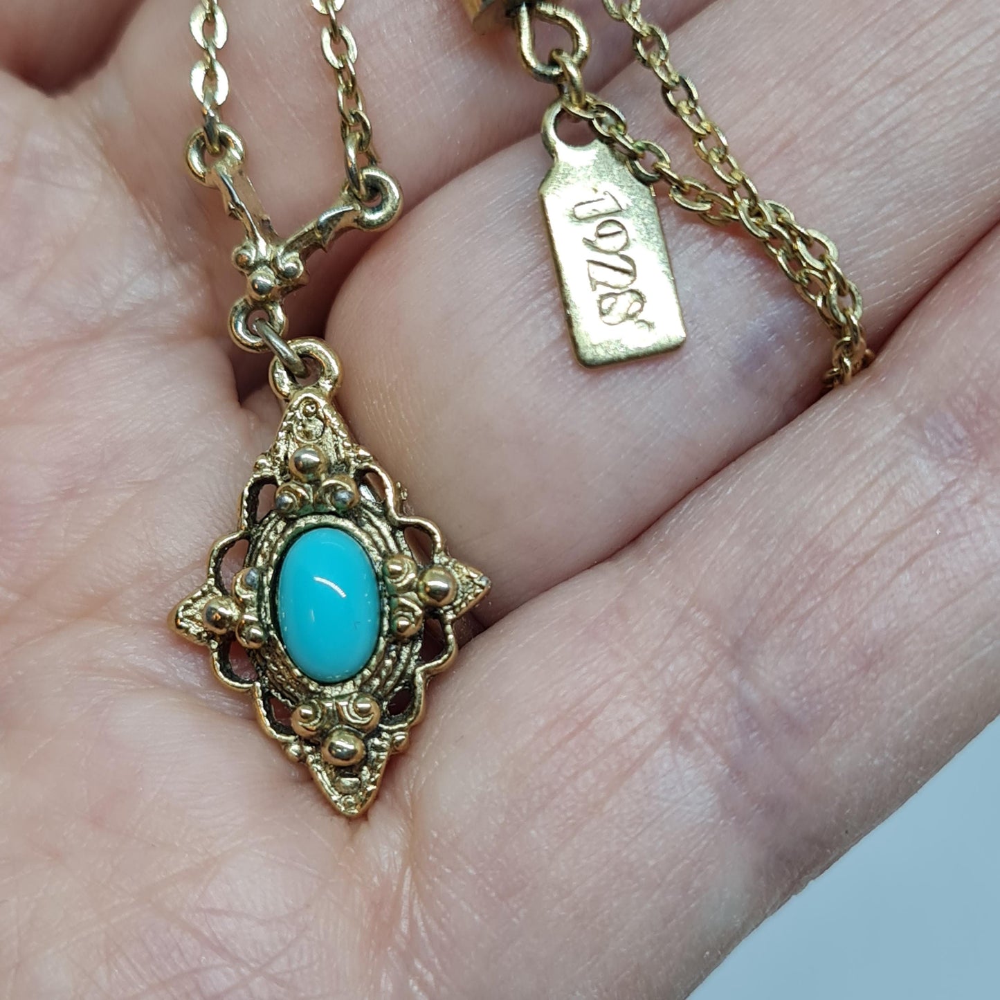 Vintage 1928 JEWELRY pendant necklace Gold-tone chain and tiny pendant with blue glass cabochon