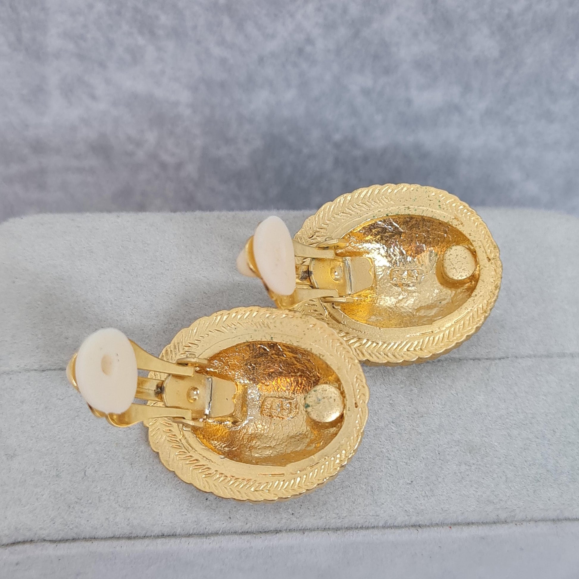 Vintage heraldic style clip-on earrings Matte gold tone textured metal oval clip earrings