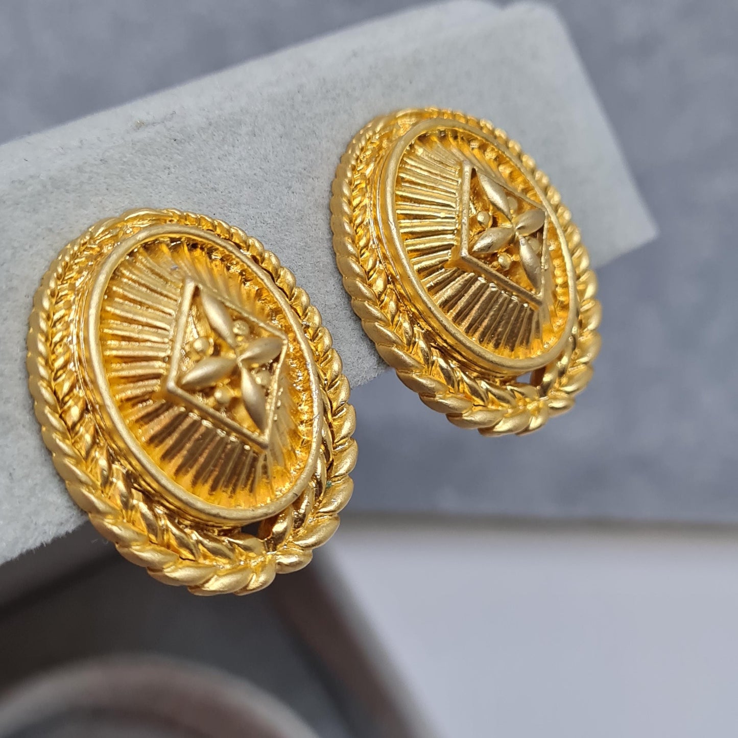 Vintage heraldic style clip-on earrings Matte gold tone textured metal oval clip earrings
