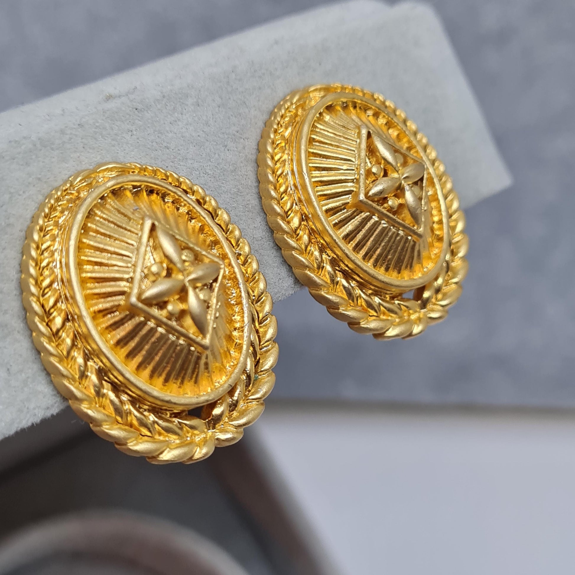 Vintage heraldic style clip-on earrings Matte gold tone textured metal oval clip earrings