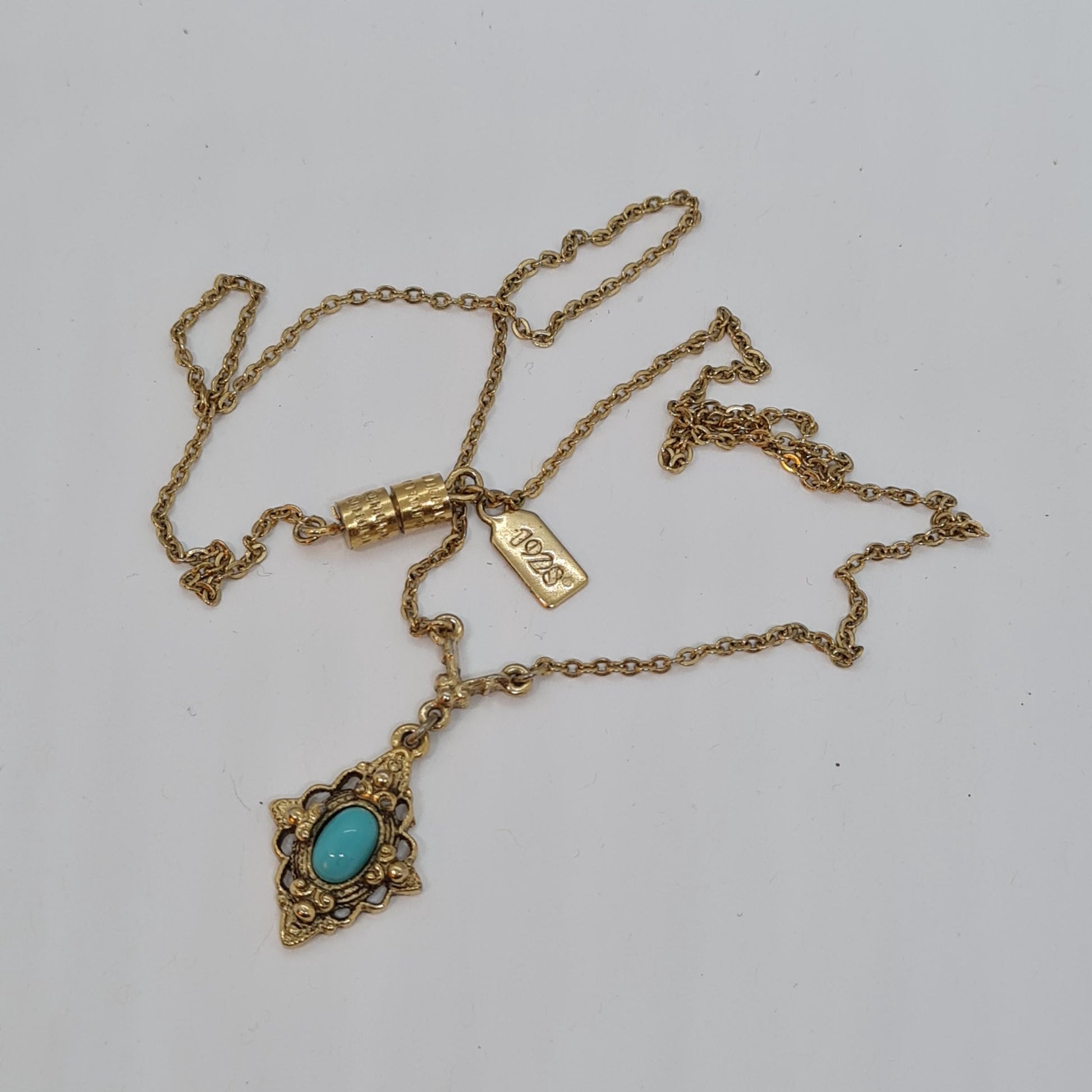 Vintage 1928 JEWELRY pendant necklace Gold-tone chain and tiny pendant with blue glass cabochon