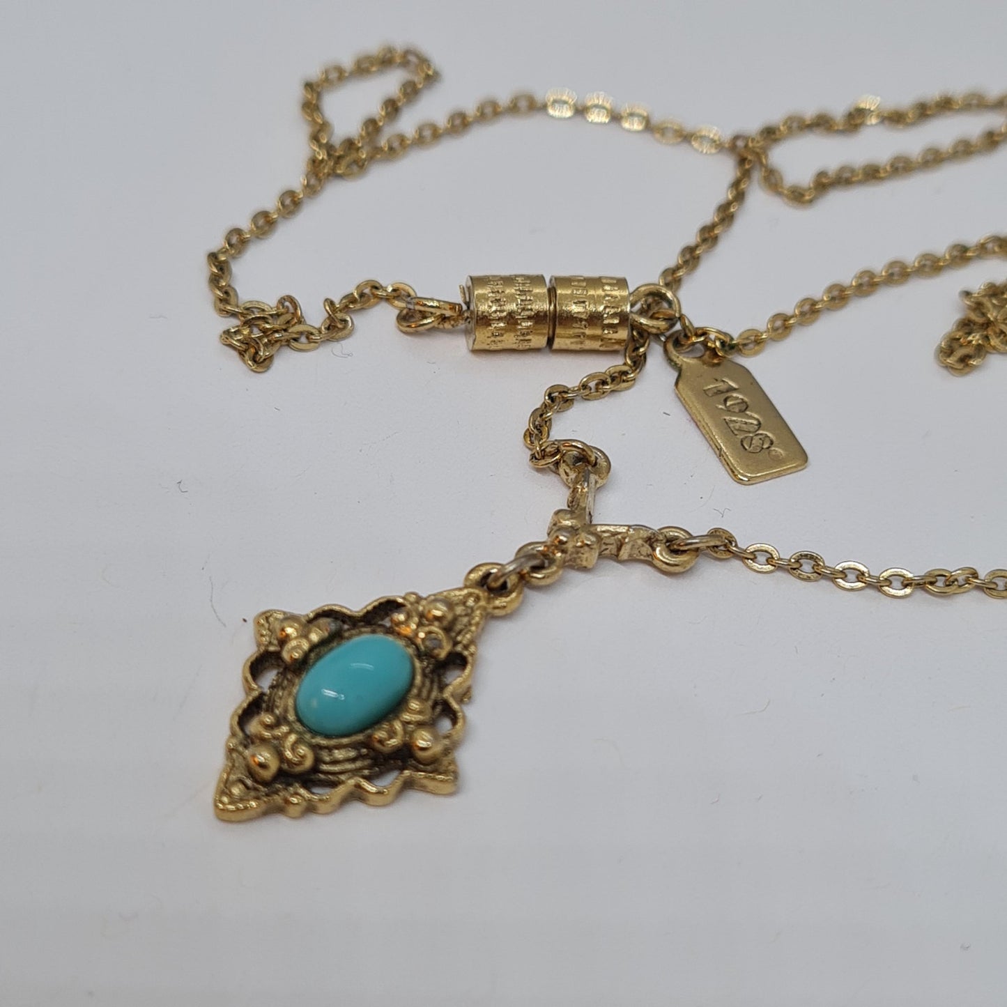 Vintage 1928 JEWELRY pendant necklace Gold-tone chain and tiny pendant with blue glass cabochon
