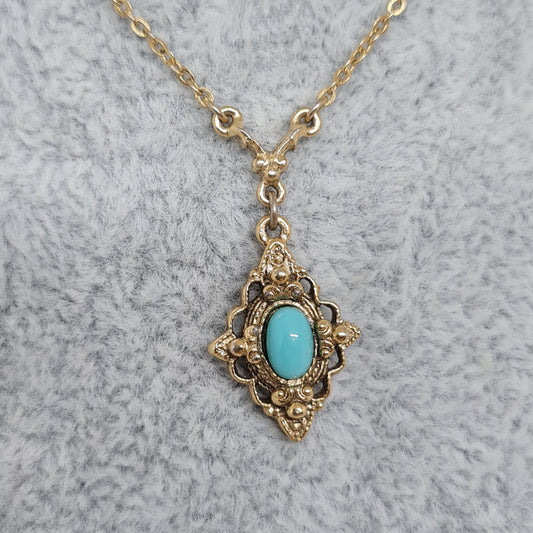 Vintage 1928 JEWELRY pendant necklace Gold-tone chain and tiny pendant with blue glass cabochon