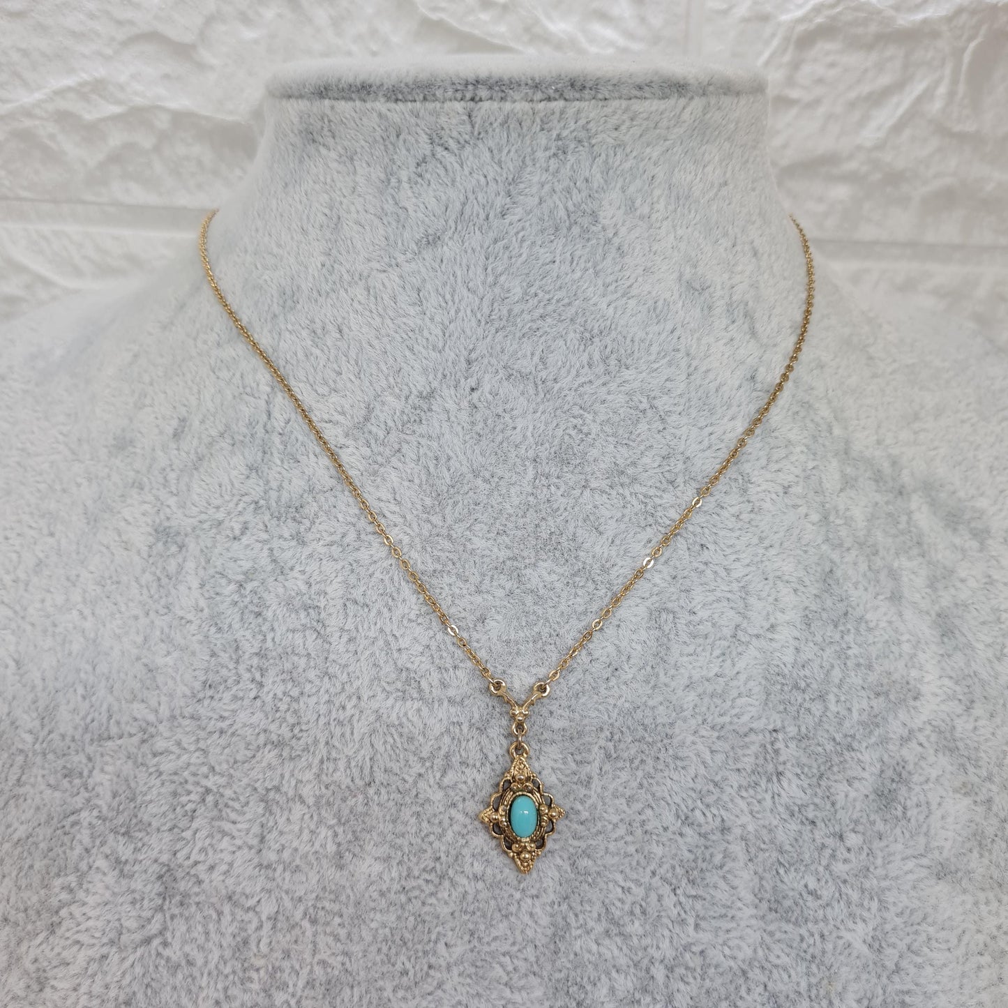 Vintage 1928 JEWELRY pendant necklace Gold-tone chain and tiny pendant with blue glass cabochon