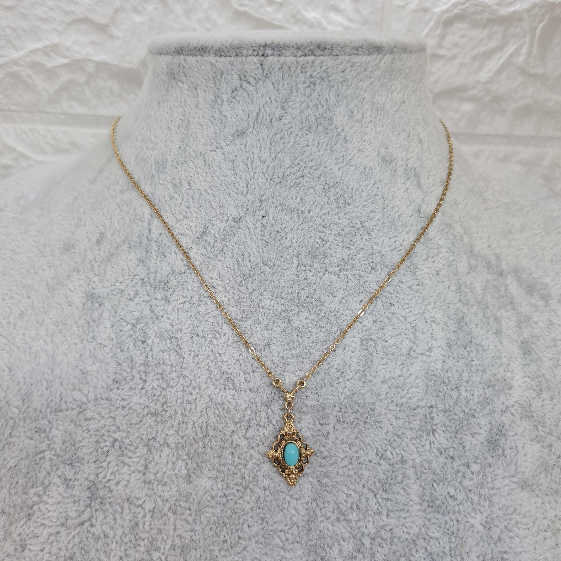 Vintage 1928 JEWELRY pendant necklace Gold-tone chain and tiny pendant with blue glass cabochon