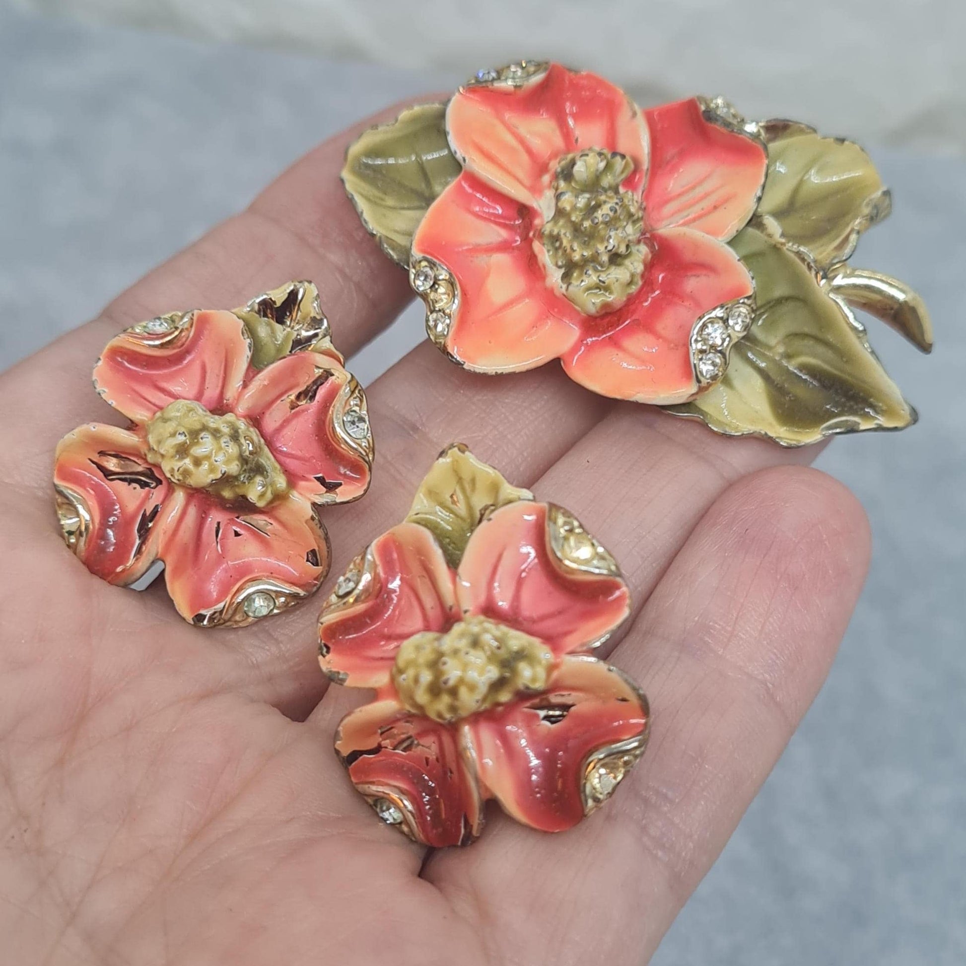 Vintage floral jewelry set, Gold-tone metal, glass rhinestone, Red and green enamel brooch, and clip-on earrings set