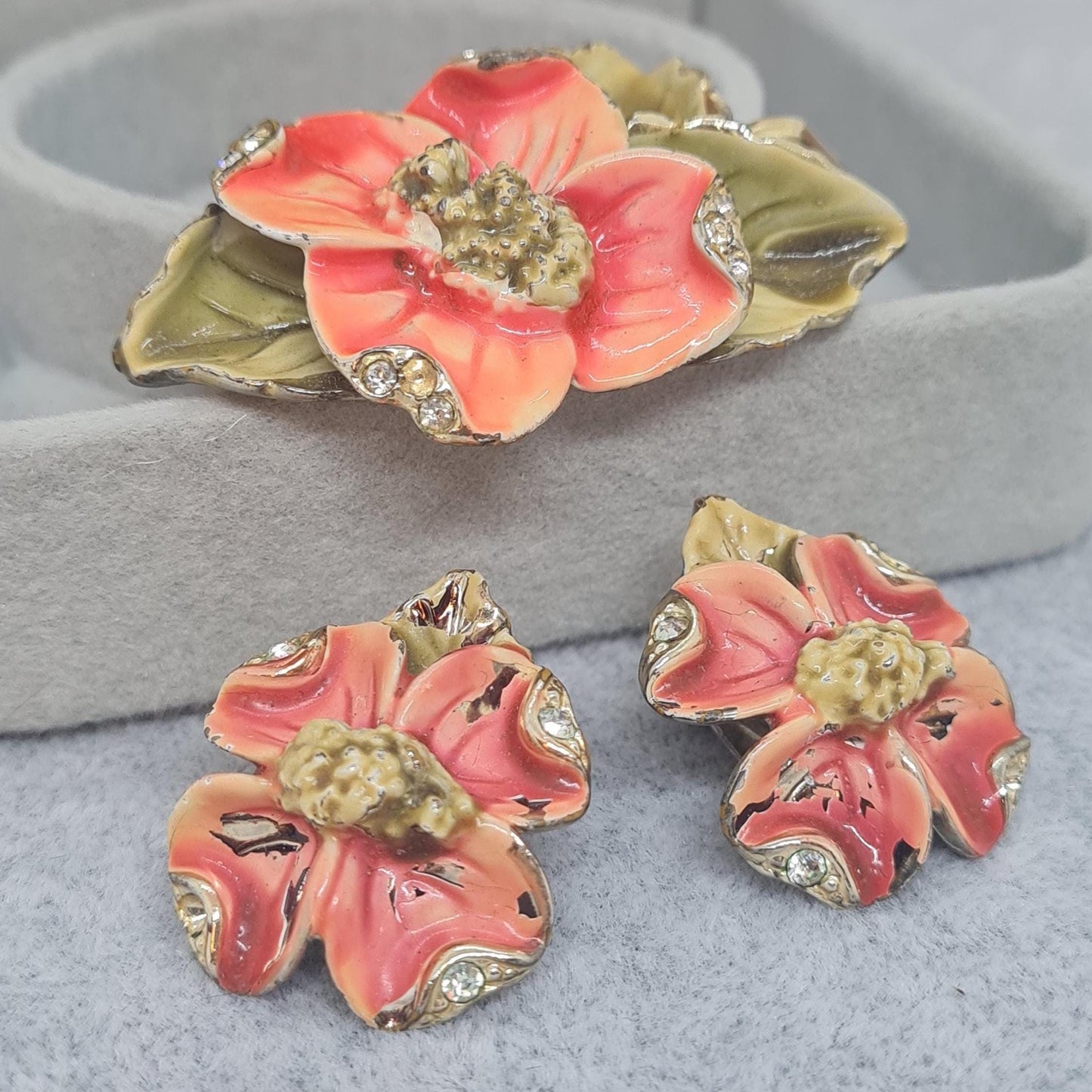 Vintage floral jewelry set, Gold-tone metal, glass rhinestone, Red and green enamel brooch, and clip-on earrings set
