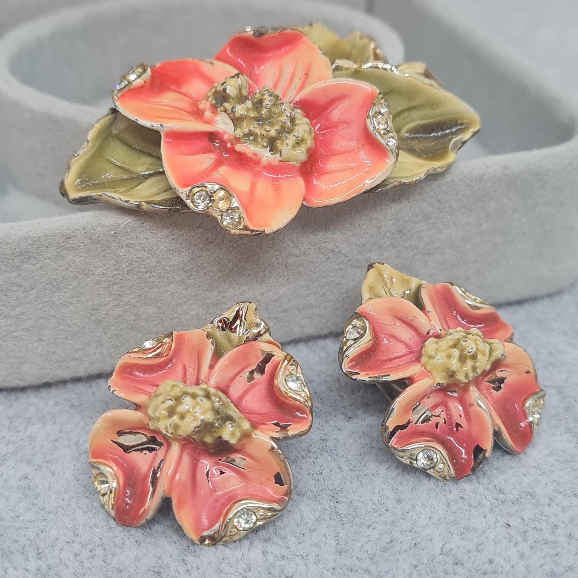 Vintage floral jewelry set, Gold-tone metal, glass rhinestone, Red and green enamel brooch, and clip-on earrings set