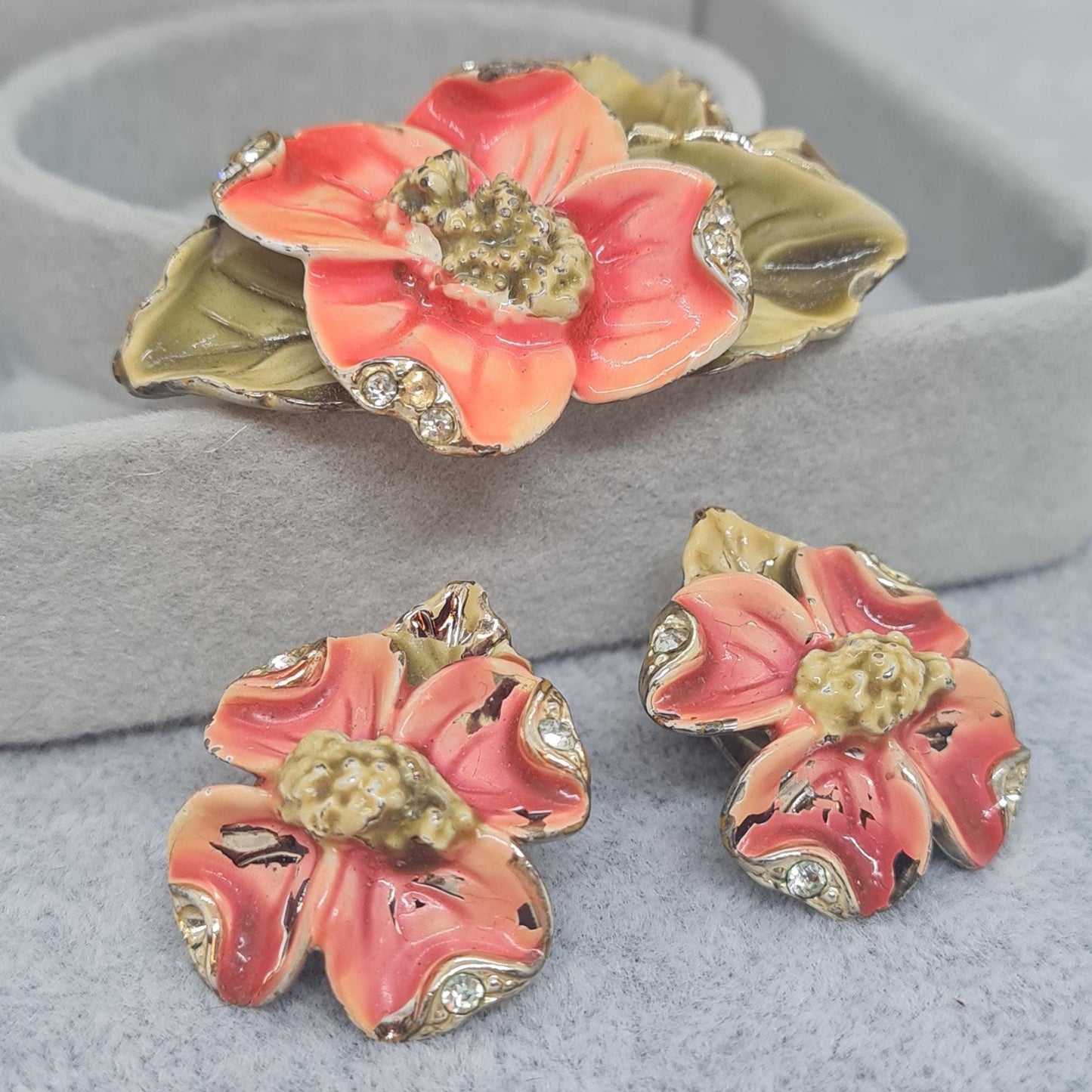 Vintage floral jewelry set, Gold-tone metal, glass rhinestone, Red and green enamel brooch, and clip-on earrings set