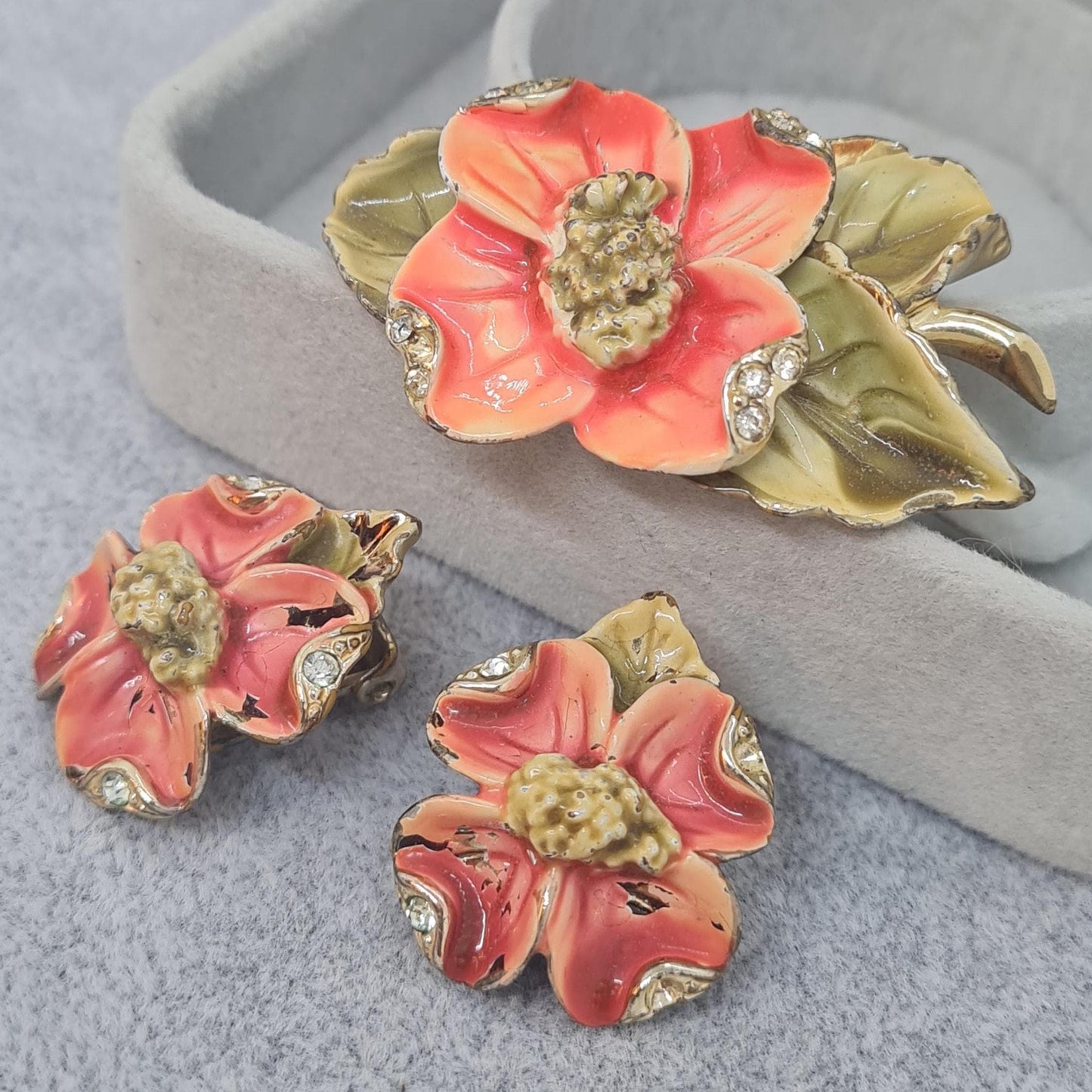 Vintage floral jewelry set, Gold-tone metal, glass rhinestone, Red and green enamel brooch, and clip-on earrings set