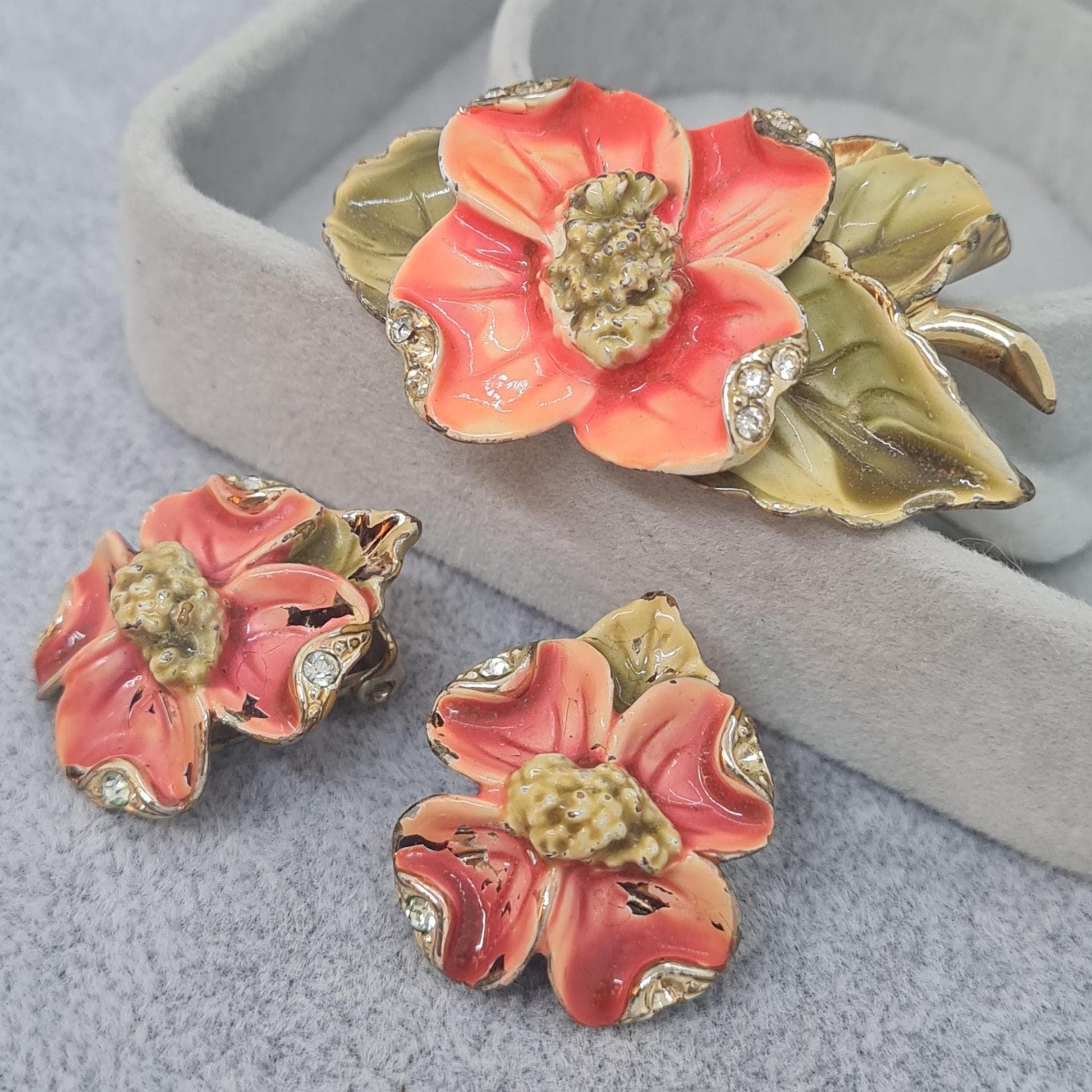 Vintage floral jewelry set, Gold-tone metal, glass rhinestone, Red and green enamel brooch, and clip-on earrings set