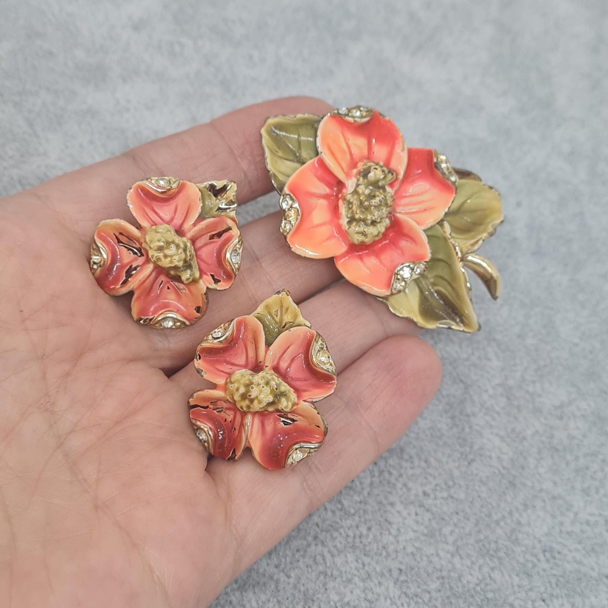 Vintage floral jewelry set, Gold-tone metal, glass rhinestone, Red and green enamel brooch, and clip-on earrings set