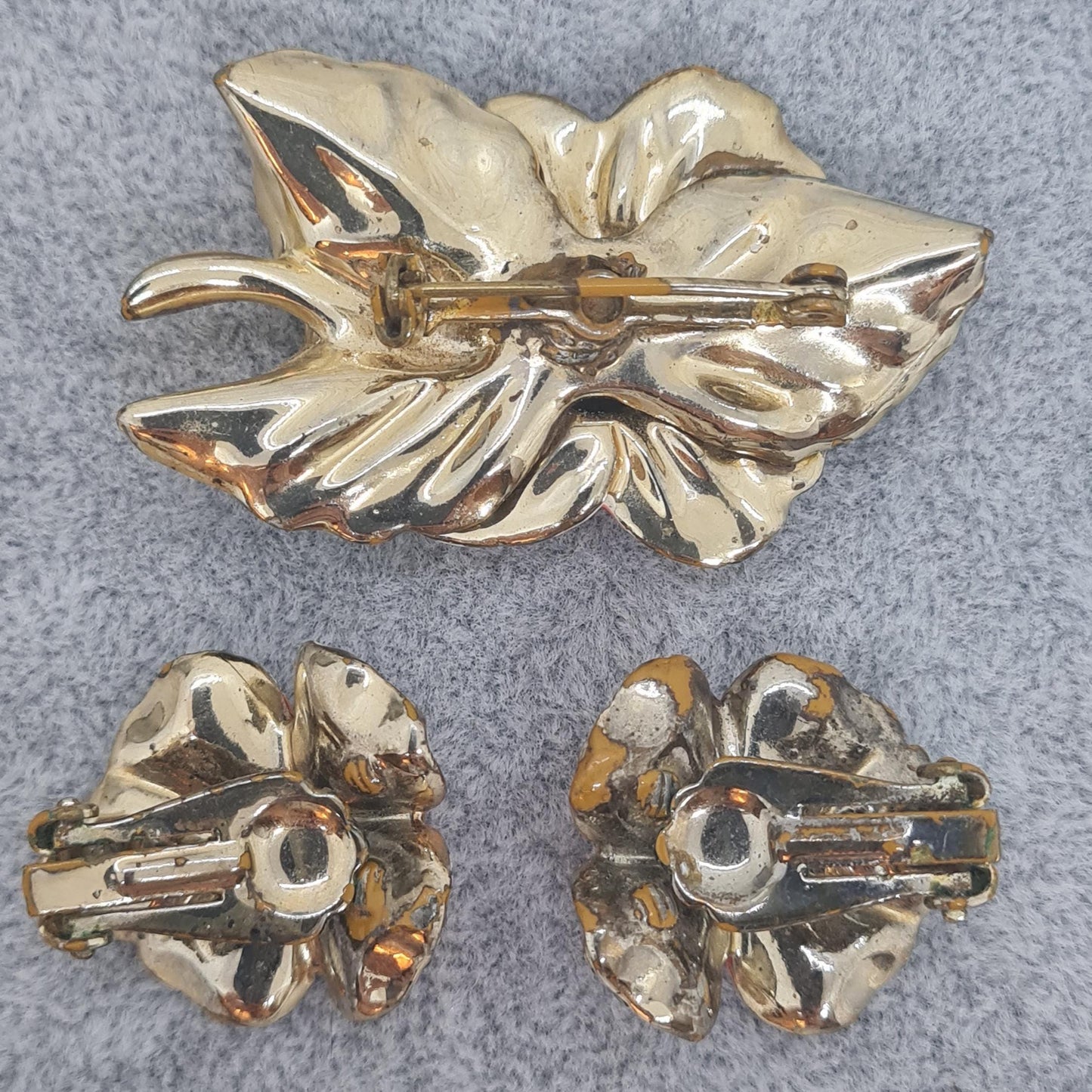 Vintage floral jewelry set, Gold-tone metal, glass rhinestone, Red and green enamel brooch, and clip-on earrings set