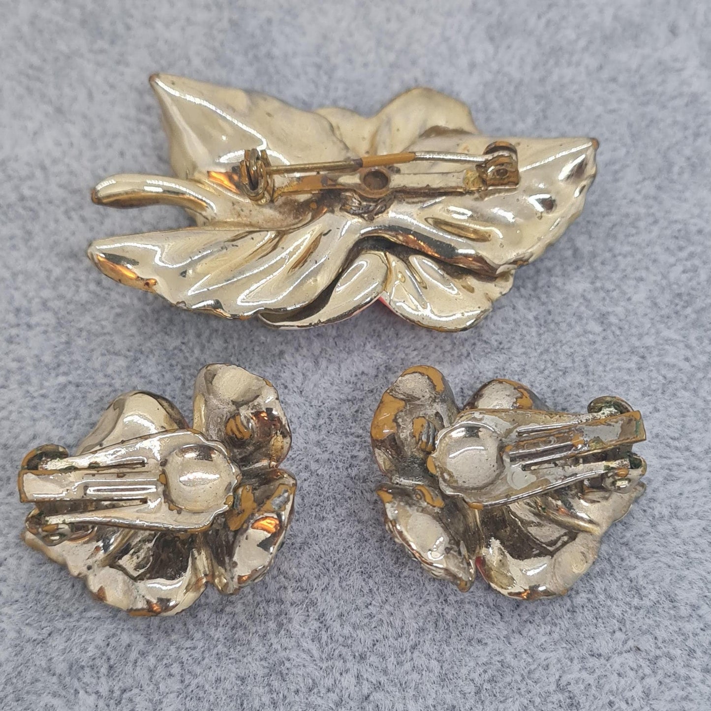 Vintage floral jewelry set, Gold-tone metal, glass rhinestone, Red and green enamel brooch, and clip-on earrings set