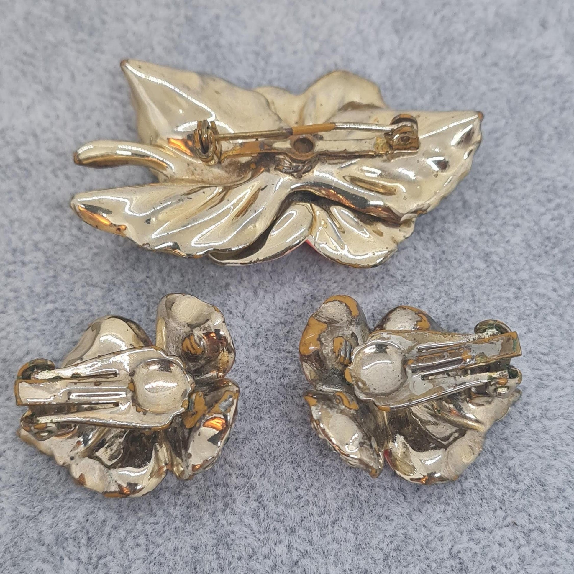 Vintage floral jewelry set, Gold-tone metal, glass rhinestone, Red and green enamel brooch, and clip-on earrings set