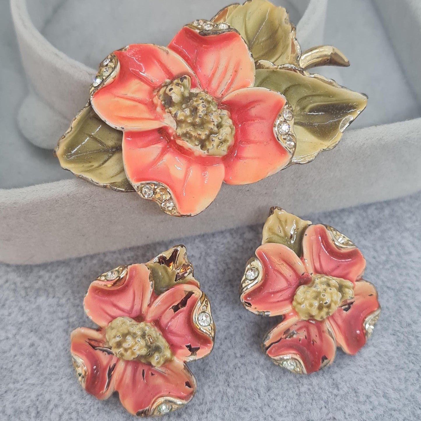 Vintage floral jewelry set, Gold-tone metal, glass rhinestone, Red and green enamel brooch, and clip-on earrings set