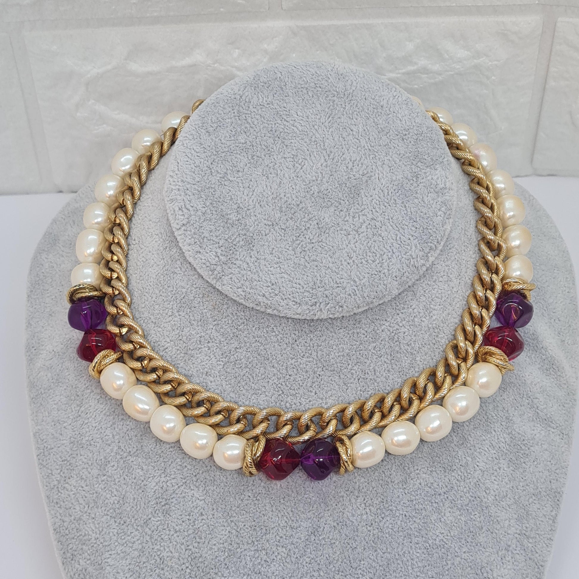 Vintage two-strand necklace with a gold-tone chain, plastic beads, and faux pearls.