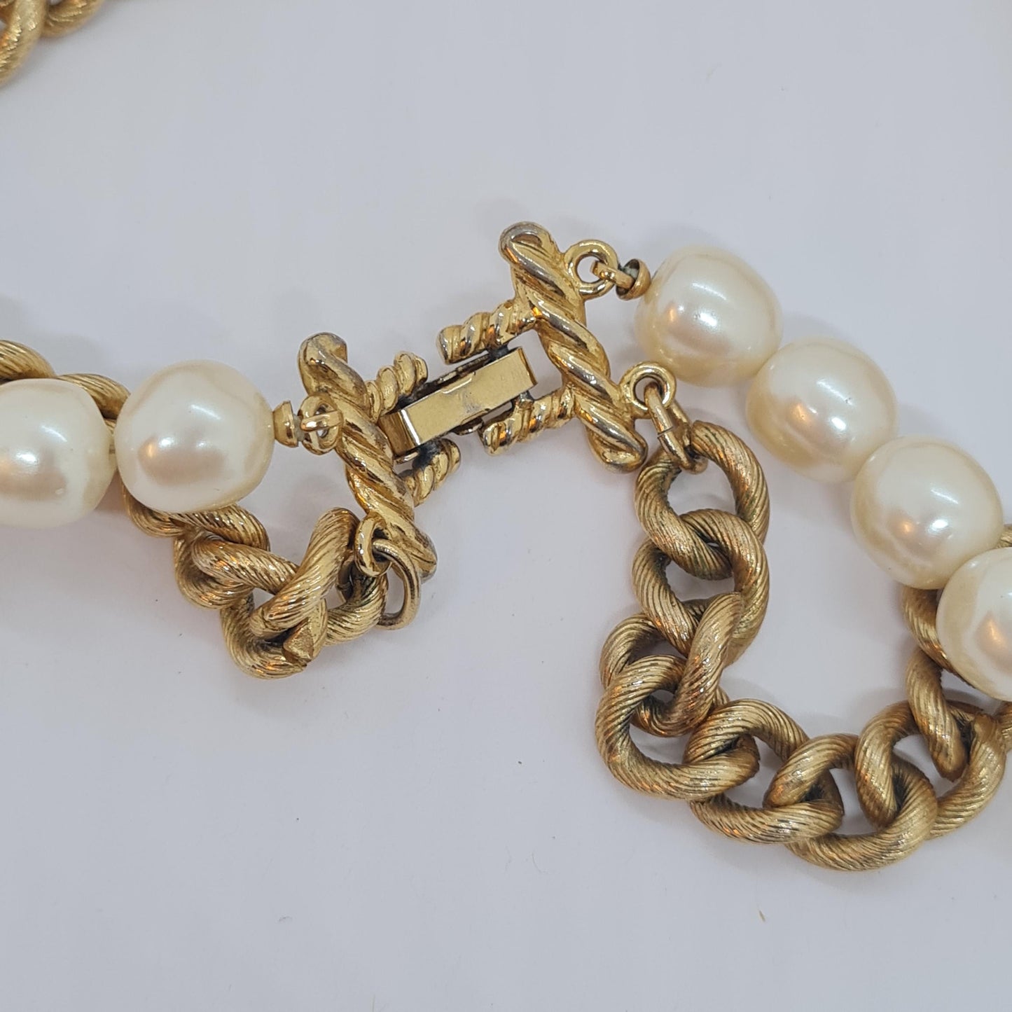 Vintage two-strand necklace with a gold-tone chain, plastic beads, and faux pearls.
