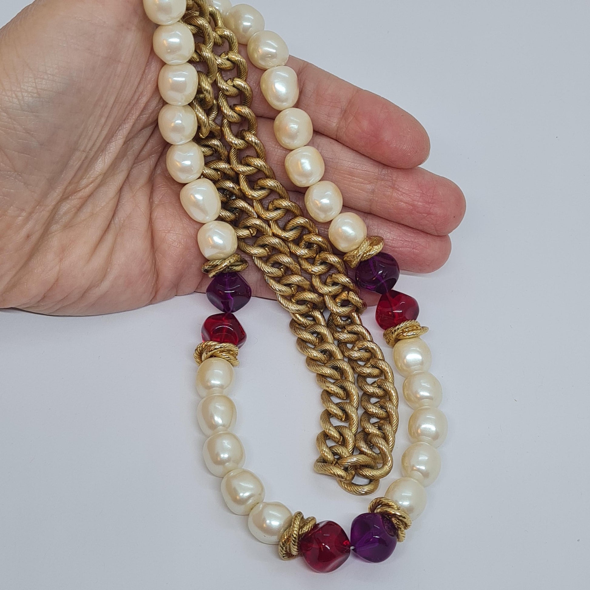 Vintage two-strand necklace with a gold-tone chain, plastic beads, and faux pearls.