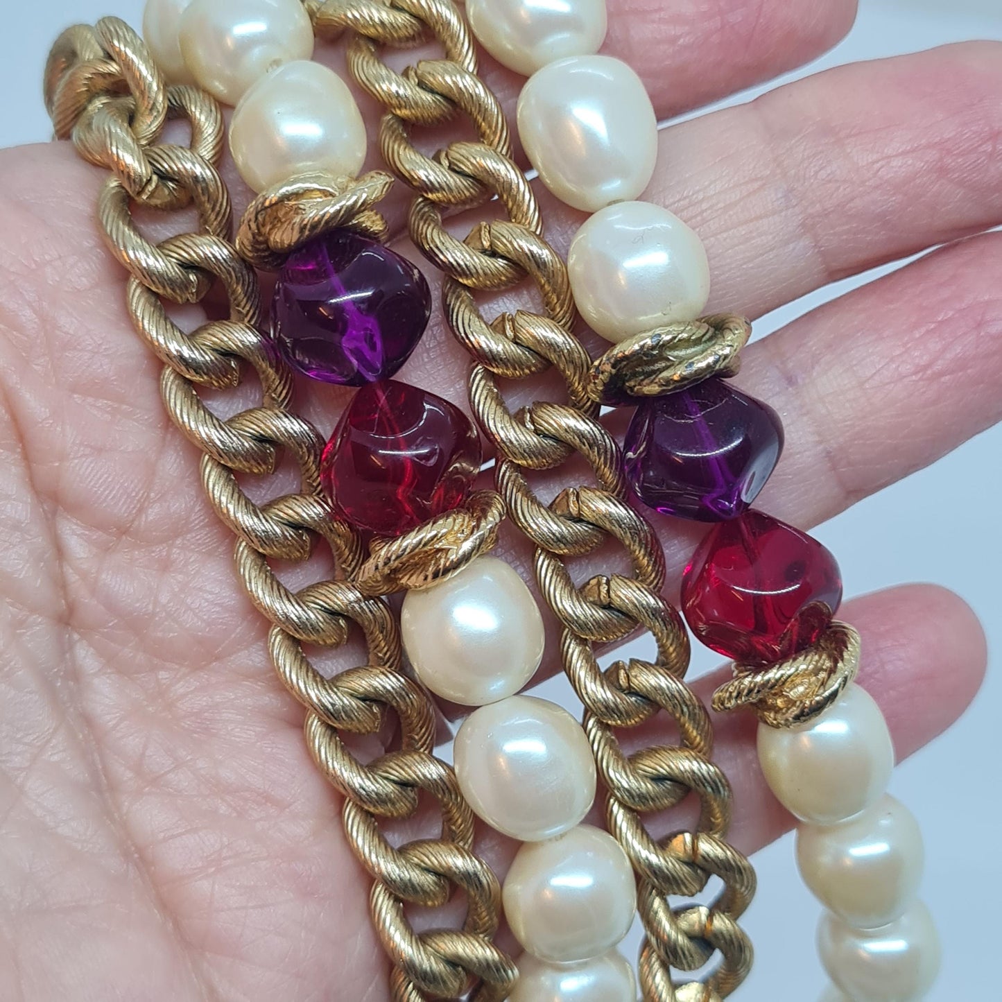 Vintage two-strand necklace with a gold-tone chain, plastic beads, and faux pearls.